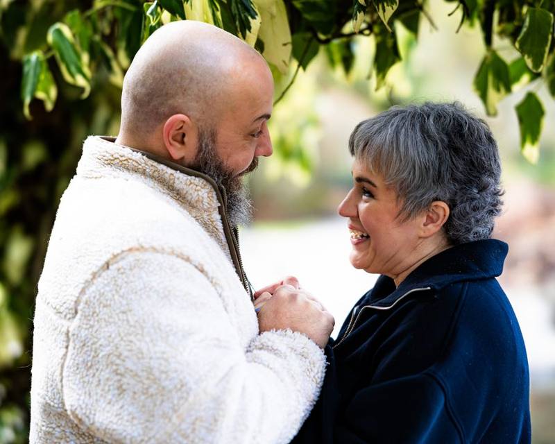 Couple looking into each other's eyes beside the water