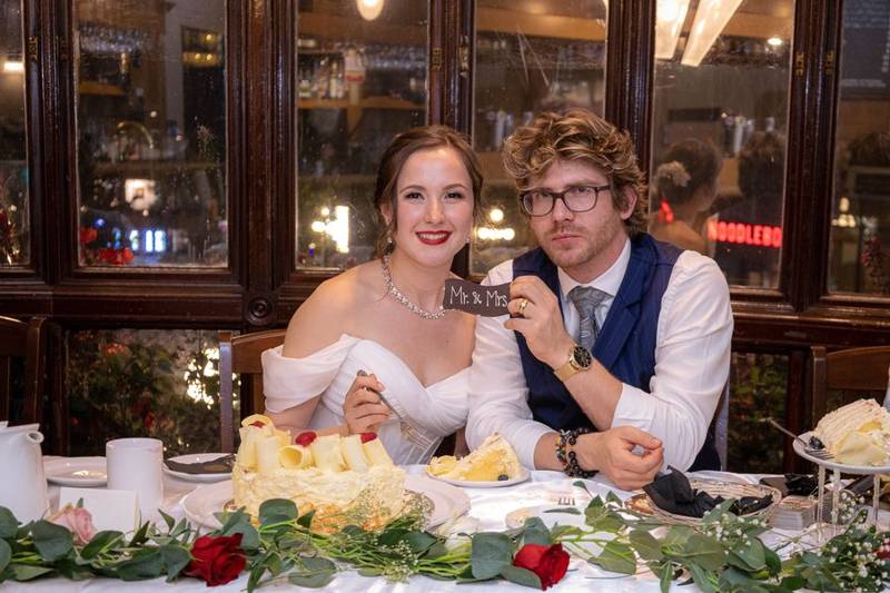 Bride and groom smiling at their reception table