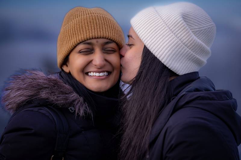 Pinky and Shika, a cheek kiss with the Whistler mountains behind